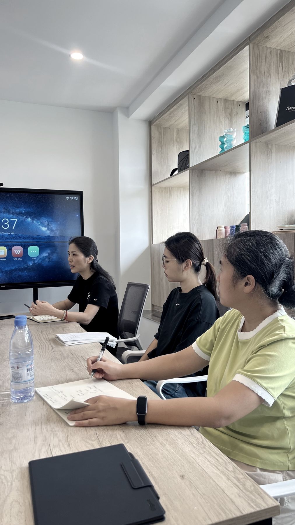 Colleagues reviewing a project on screen in the meeting room