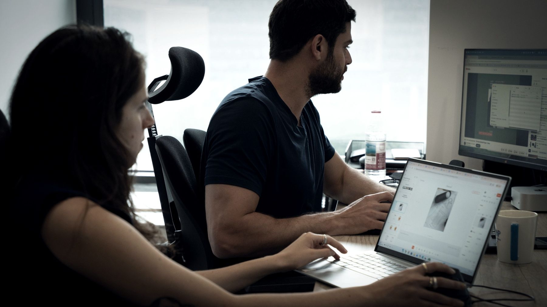Two colleagues checking a product against the drawing on screen